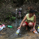 Yanira Rios collects spring water for use in her house, which is without running water or electricity, in Utuado, Puerto Rico, on Oct. 10, 2017, nearly three weeks after Hurricane Maria hit the island. (Mario Tama/Getty Images)